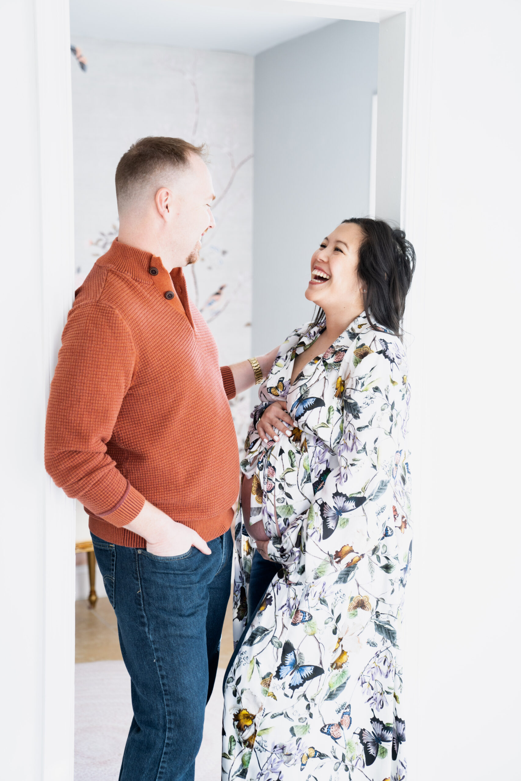 Maternity couple standing and smiling